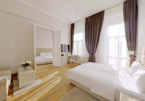 Svetla i udobno opremljena spavaća soba Lanterna Rooms City Center u istorijskoj Dunavskoj ulici u Novom Sadu.