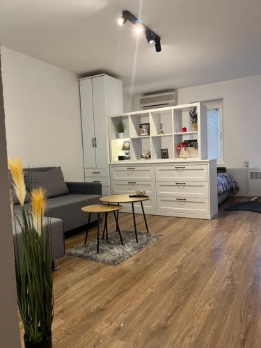 Savremeno opremljen enterijer dnevnog boravka Bellissima Apartment sa spojenom kuhinjom i trpezarijom.